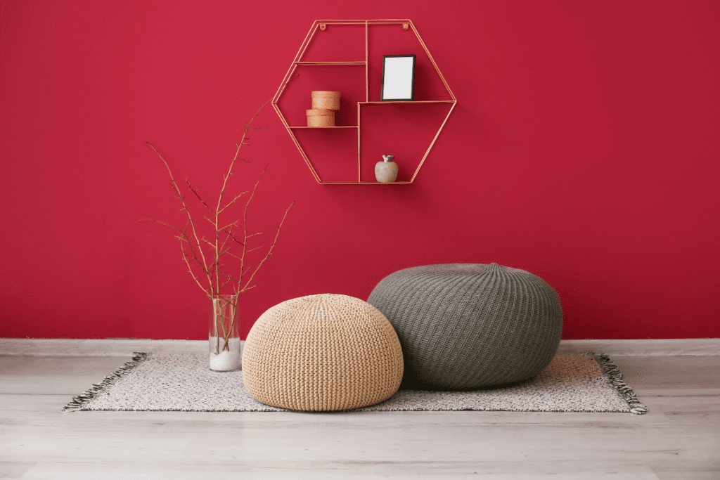 red color wall with two rest cushions