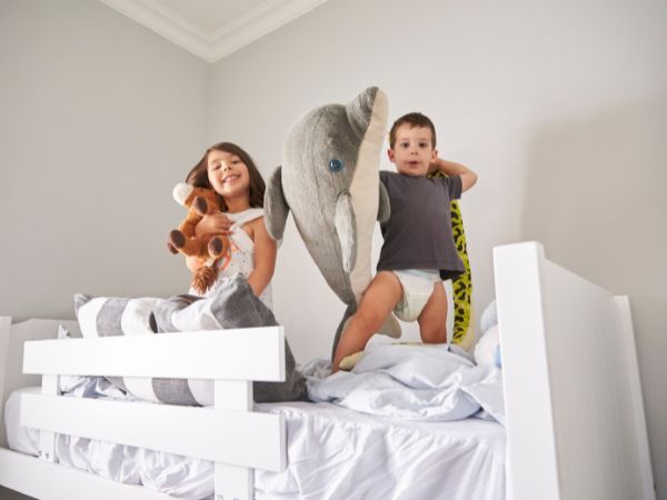 Children playing on bunk bed with stairs